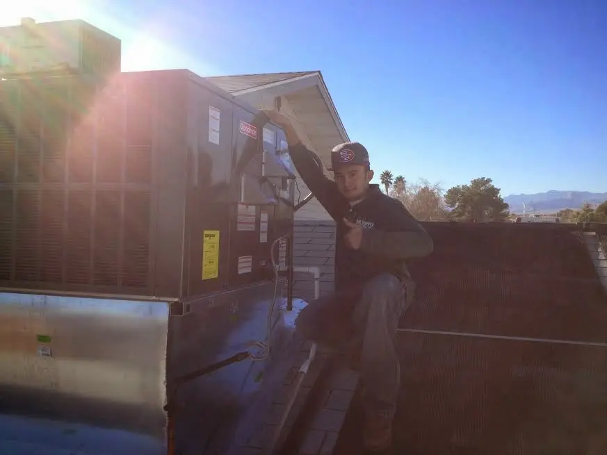 HVAC technician performing Boiler Repair on a rooftop unit in North Tustin